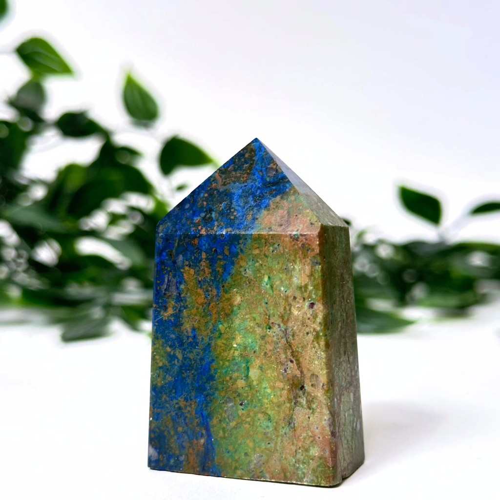 Azurite crystal tower with blue and green patterns on a white background