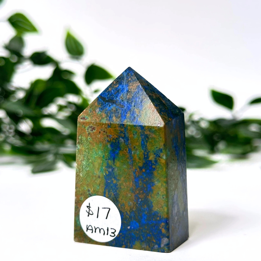 Multicolored crystal tower with a price tag on a white background