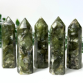 5 green mica and quartz crystal towers on a white and leafy background