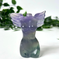 Purple fluorite crystal angel figurine with wings on a white background