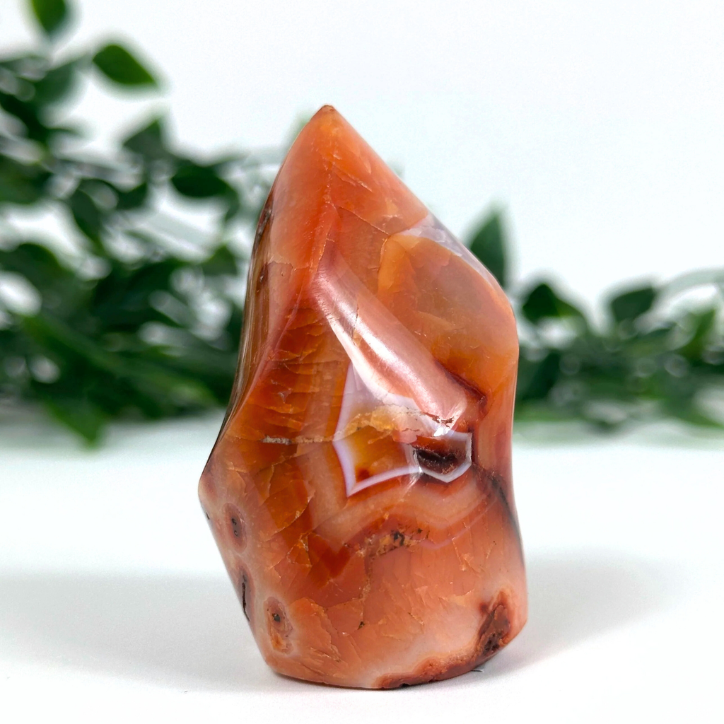 Carnelian crystal flame with a natural pattern on a white background