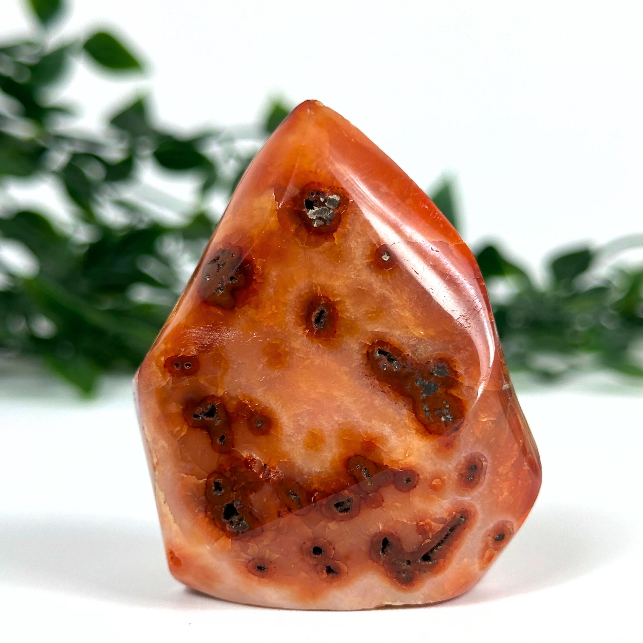 Carnelian crystal flame with brown and orange patterns on a white background