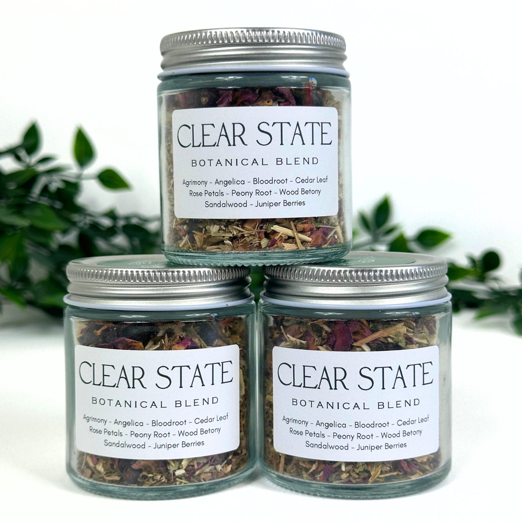 Three jars of Clear State Botanical Blend on a white background with greenery.