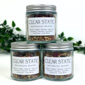 Three jars of Clear State Botanical Blend on a white background with greenery.