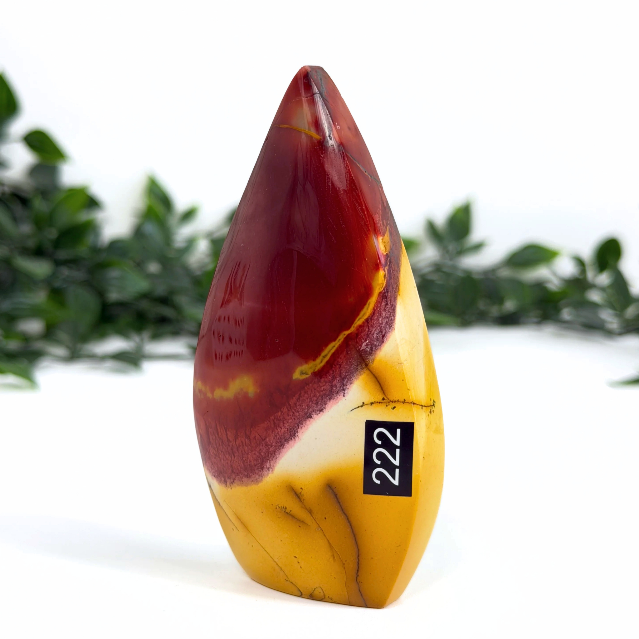 Mookaite teardrop with red and yellow colors and a black label on a white background