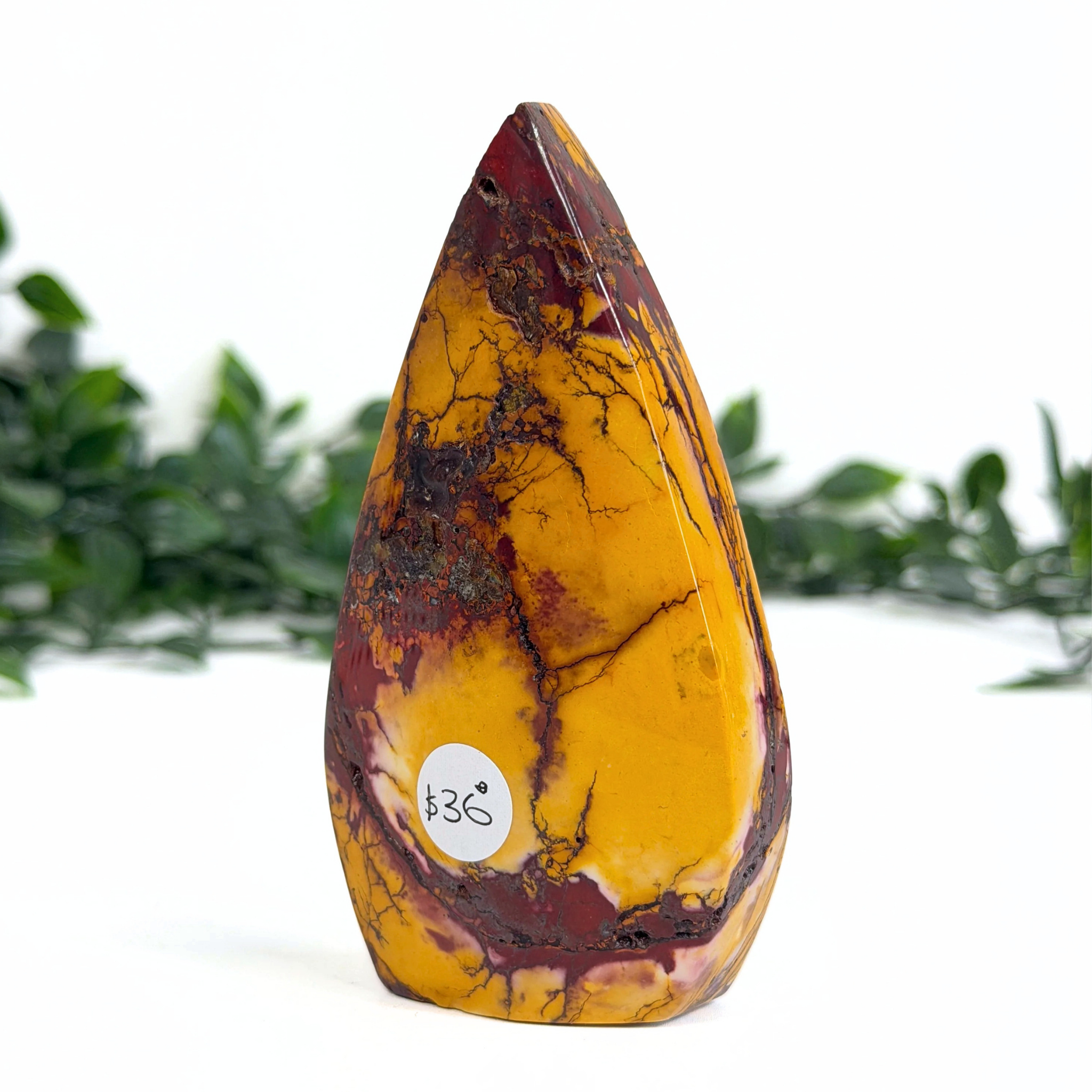 Marbled mookaite teardrop stone with a visible brand logo on a white background