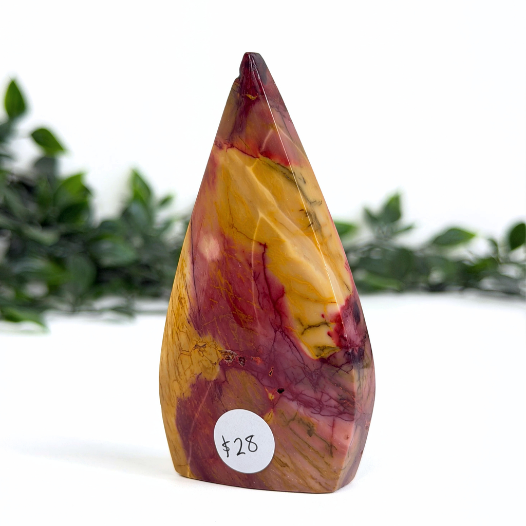 Multicolored teardrop-shaped mookaite stone with a price tag on a white background