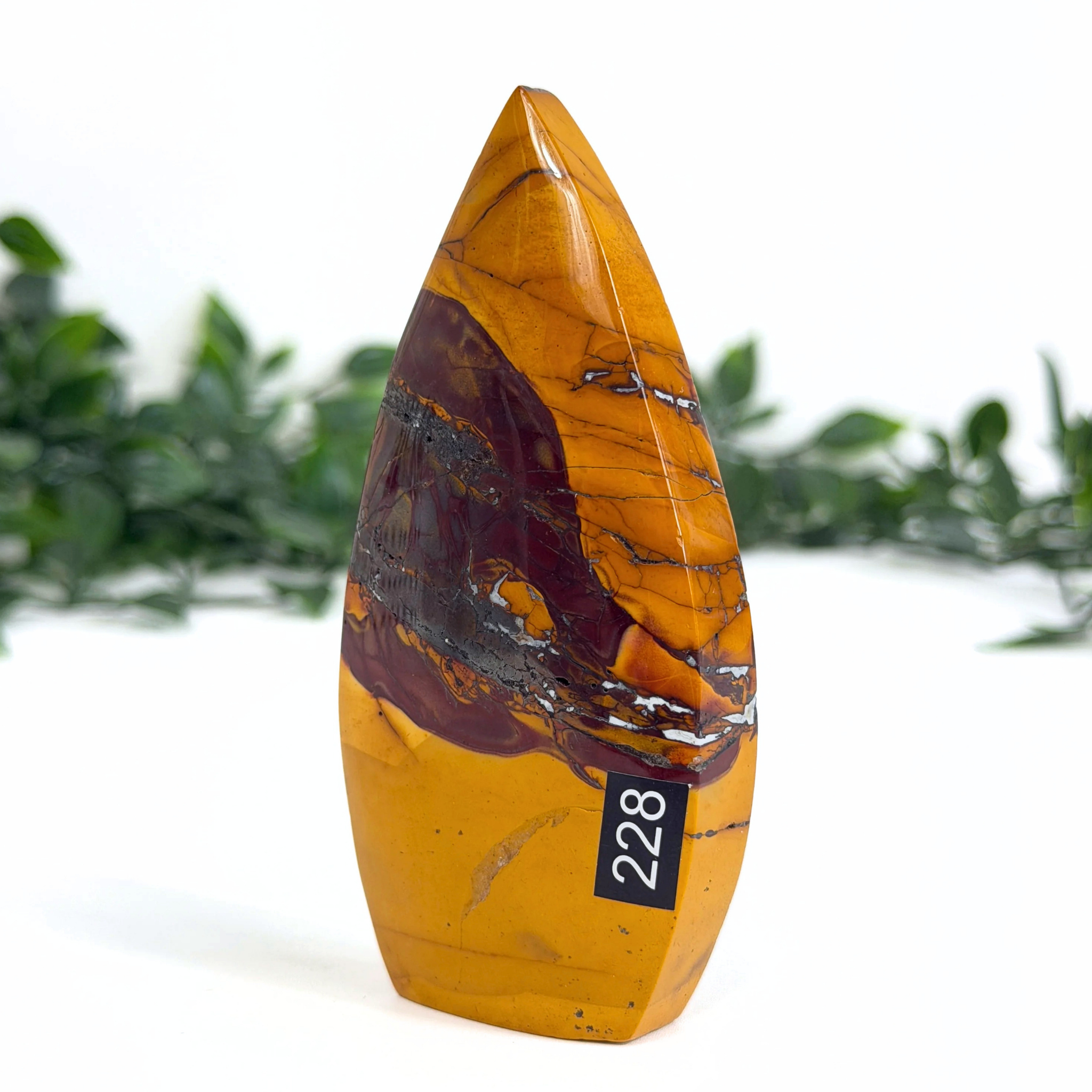Marbled mookaite crystal teardrop with a number tag on a white background