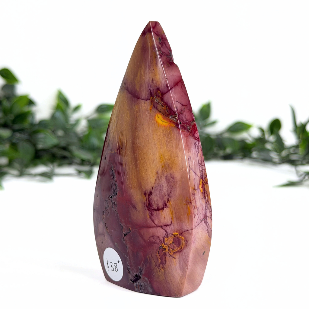 Polished mookaite teardrop with marbled pattern on a white background