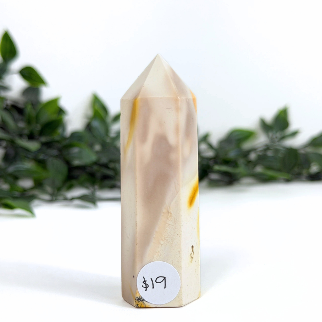 Mookaite crystal tower with a price tag on a white background with greenery