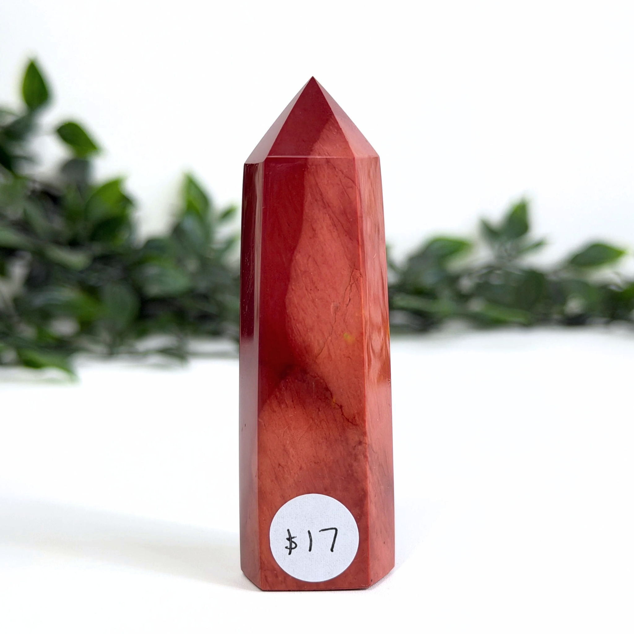 Red mookaite crystal tower with a price tag on a white background