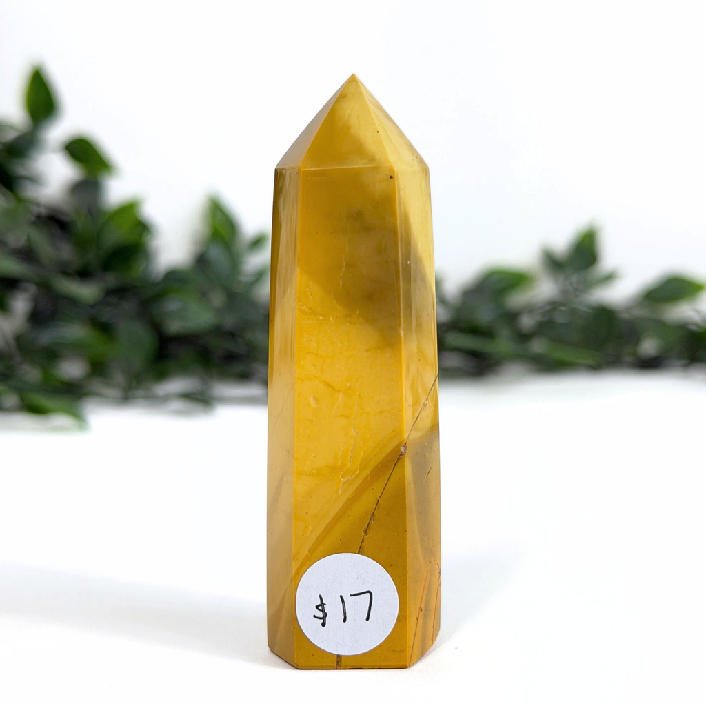 Yellow mookaite crystal tower with a price tag on a white background