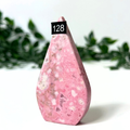 Pink peruvian rhodonite crystal flame on a white background