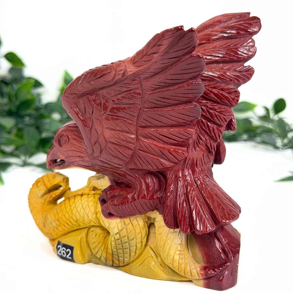 Decorative mookaite crystal figurine of an eagle with outstretched wings on a white background