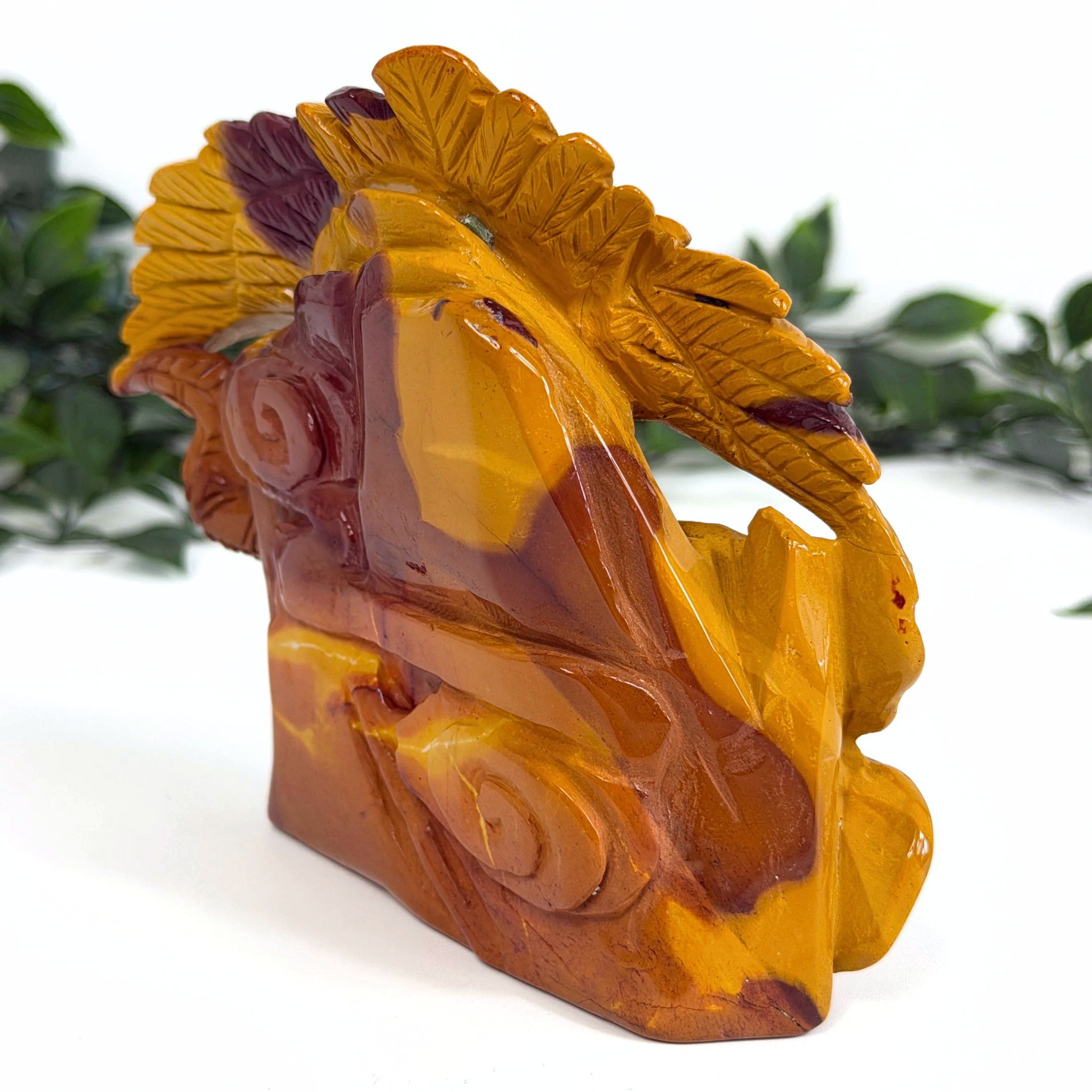 Mookaite crystal carved eagle and snake sculpture with intricate design on a white background